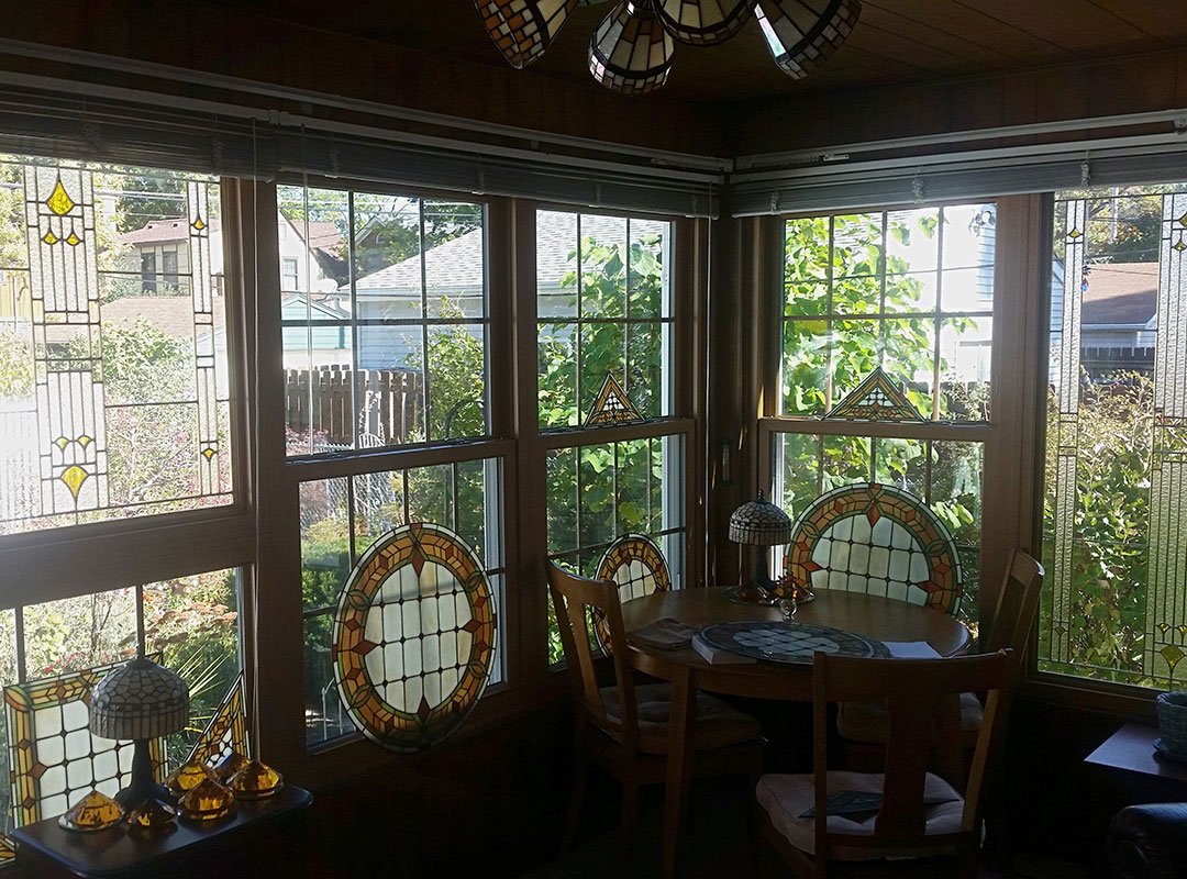 A room with a table and chairs and a window.