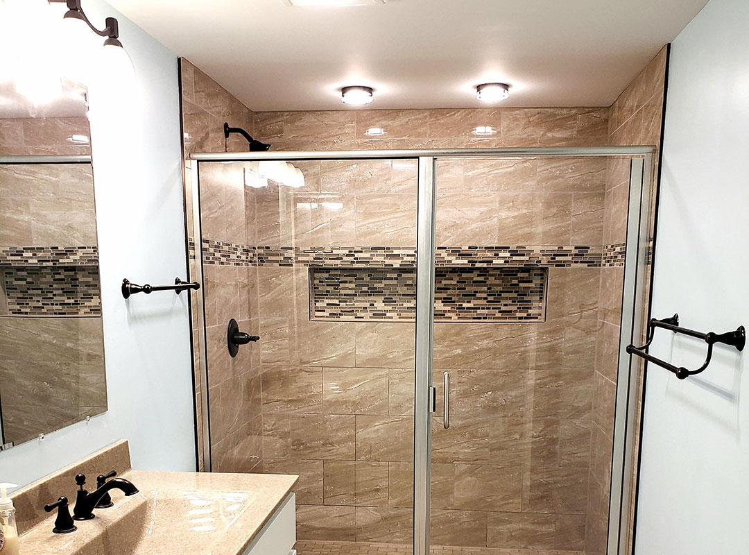 A bathroom with a glass shower door.