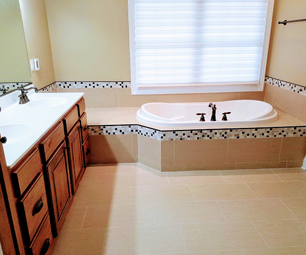 A bathroom with a tub and sink in it