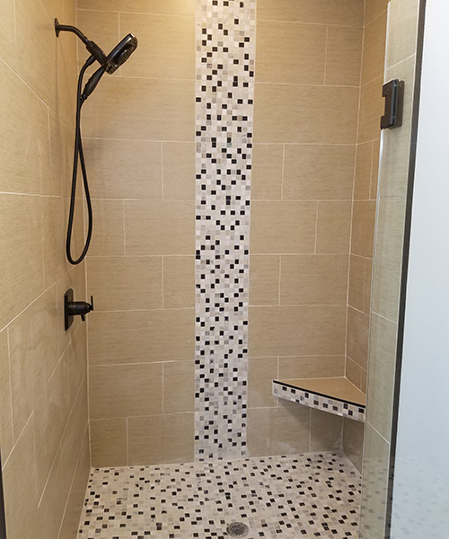 A shower area with mosaic tiles