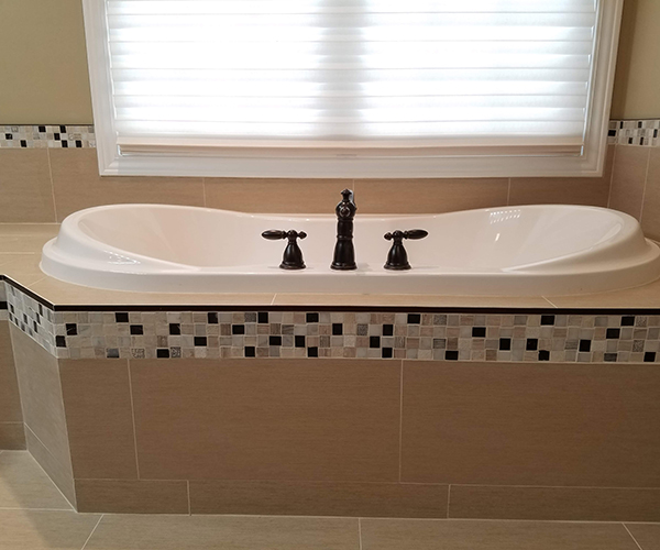 A bathroom with two sinks and a window.