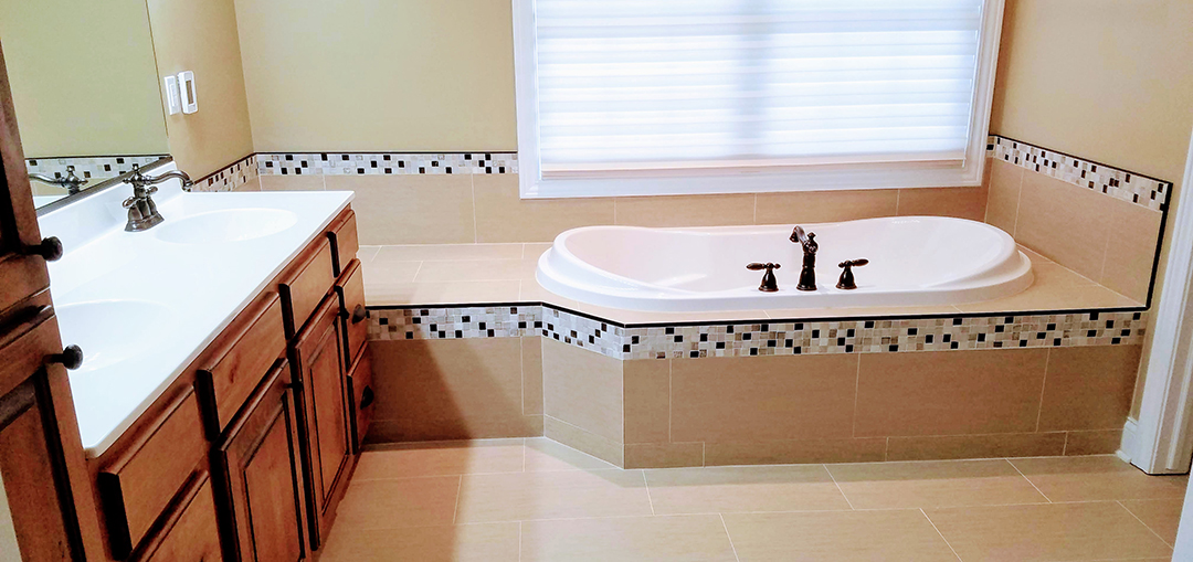 A bathroom with a tub and sink in it