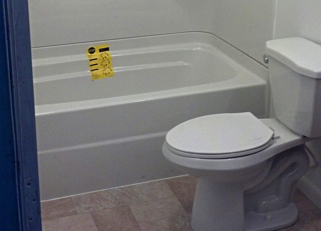 A bathtub next to a toilet