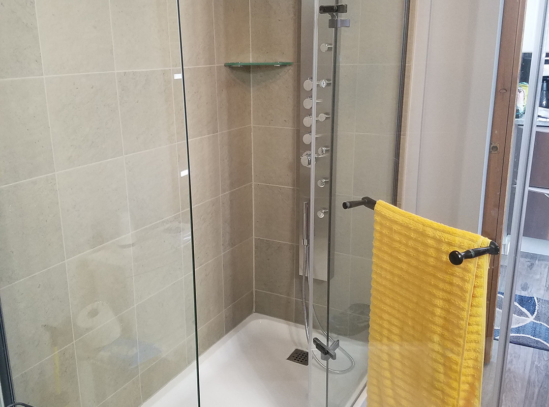 A shower area with glass walls