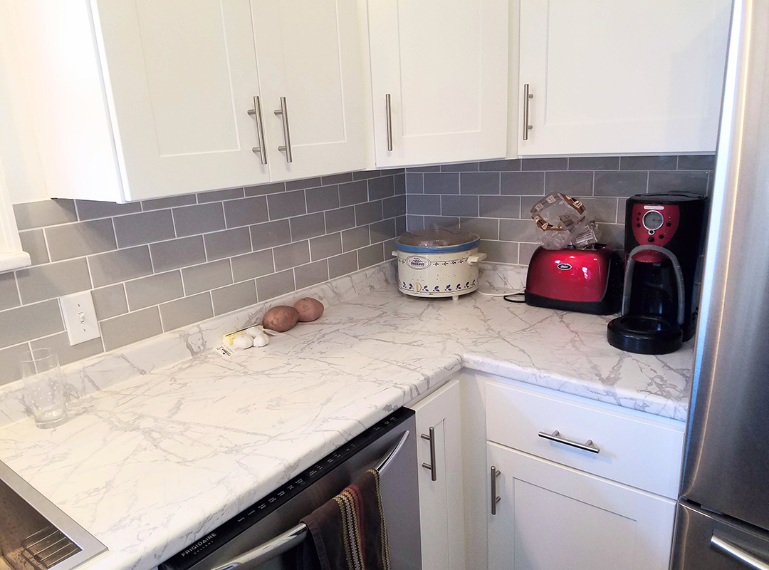 A rice cooker next to a toaster and a coffee machine