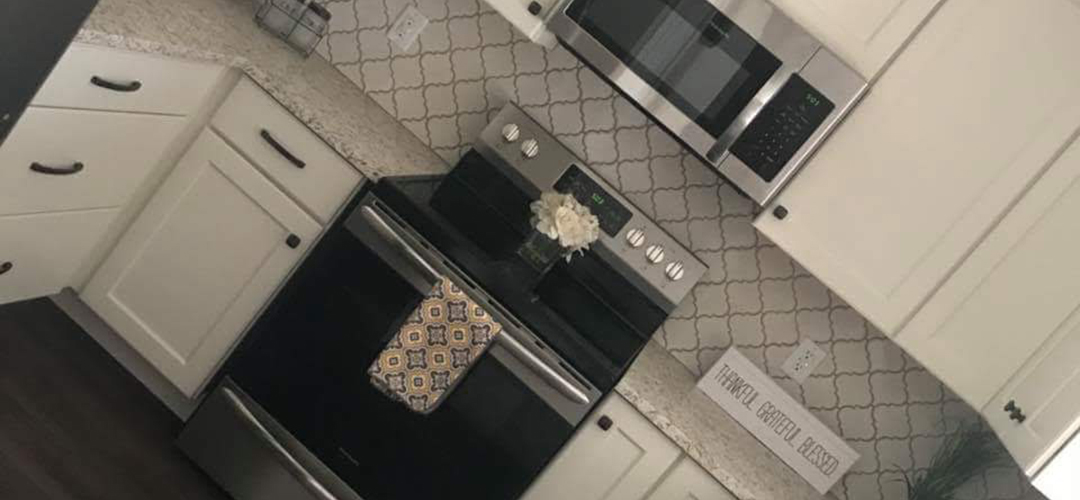 A microwave installed above an oven