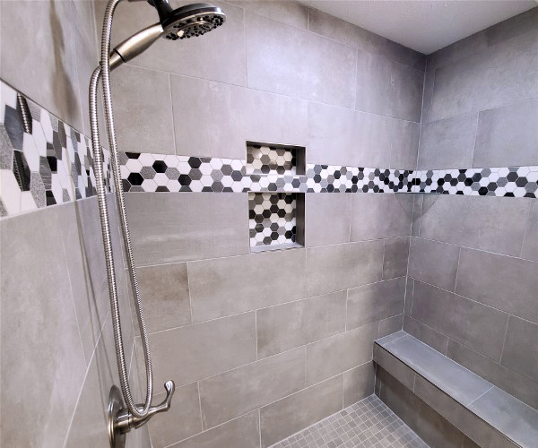 A shower area with hexagon tiles