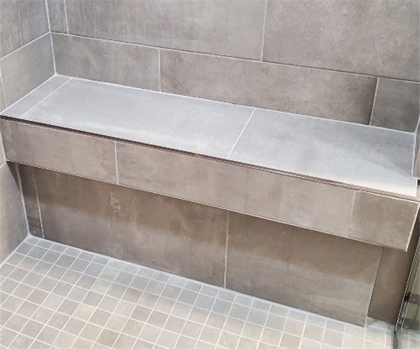 A tiled bench in a shower area