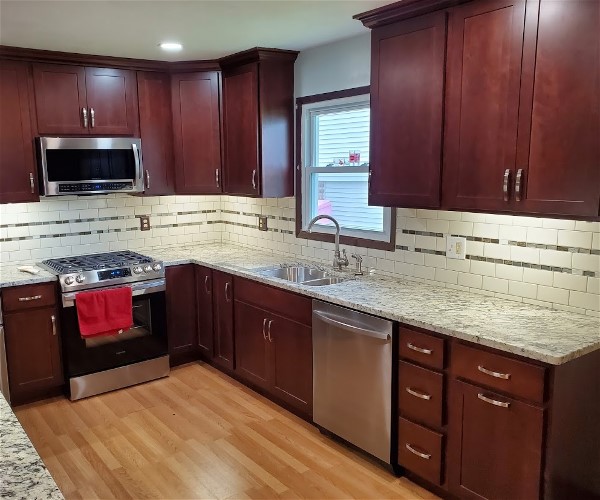 A kitchen with wooden cabinets and flooring