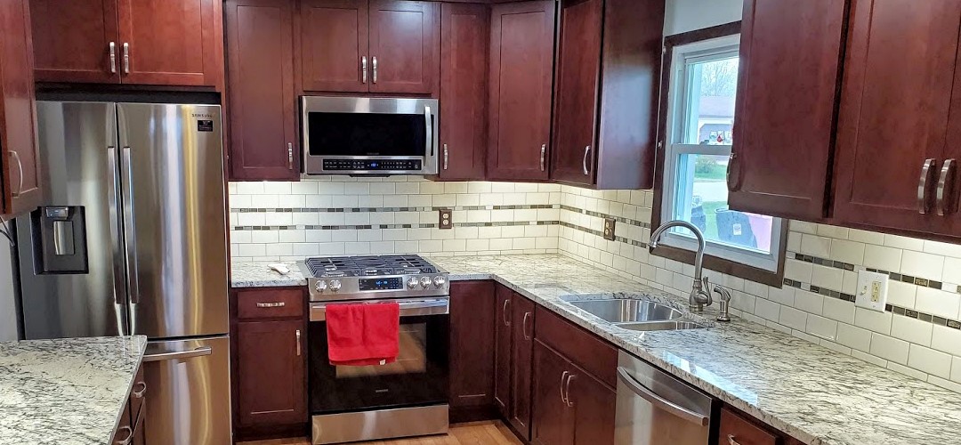 A kitchen with wooden cabinets and stainless steel appliances.