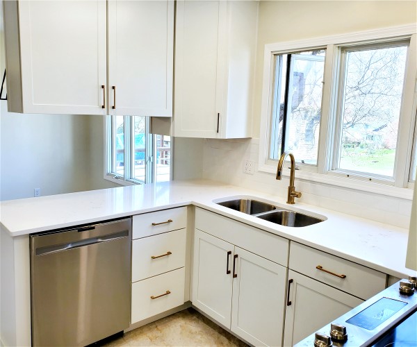 A kitchen with white cabinets and stainless steel appliances.