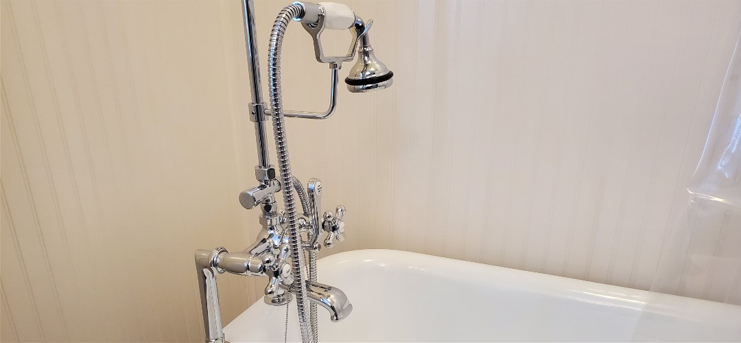 A bath tub with a shower head and faucet.