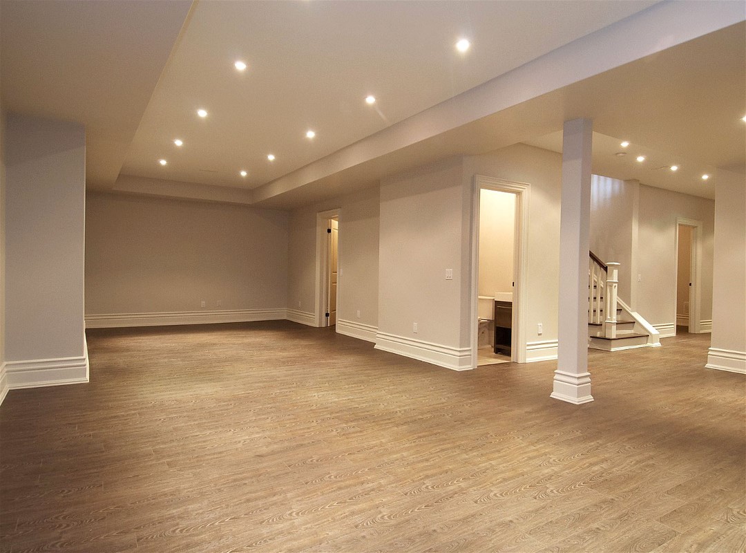 A clean and empty room with wooden flooring