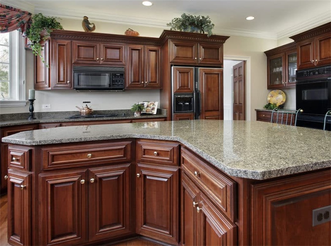 A kitchen with wooden cabinets and granite counter tops.