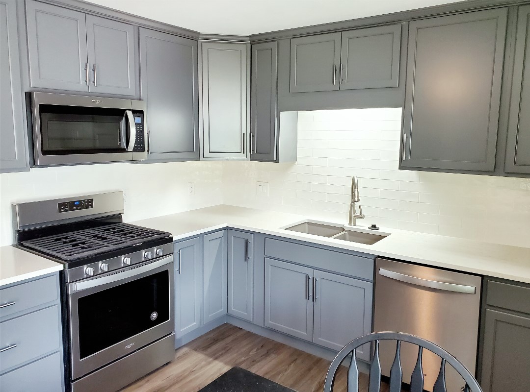 A kitchen with an oven and a microwave