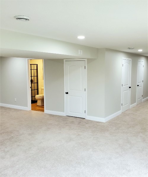 A room with many doors and white walls