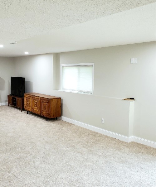 A room with a tv and a dresser in it