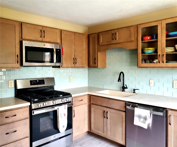 A kitchen with wooden cabinets and stainless steel appliances.