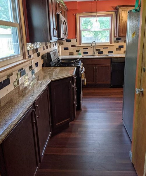 A kitchen with wood floors and white counters.