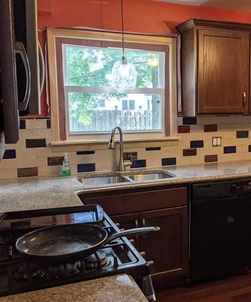 A kitchen with a stove and sink in it