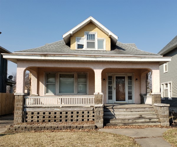 A house with steps leading to the front door.