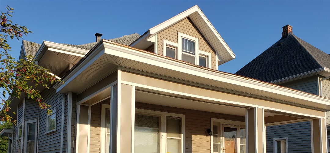 A house with a roof that has been painted tan.