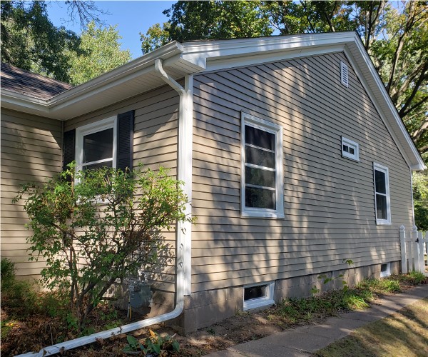 A house with a lot of windows and a gutter