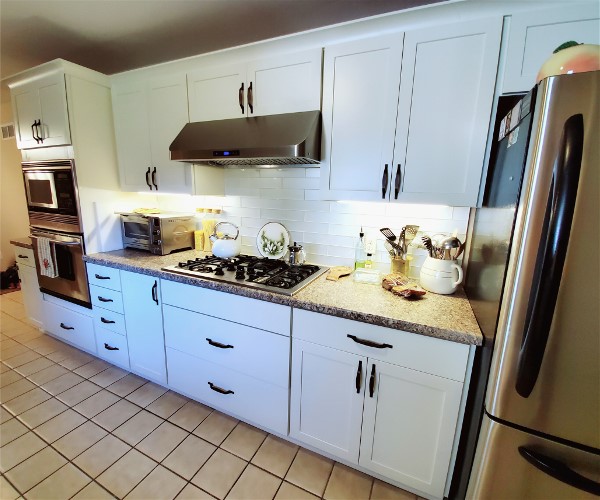 An oven toaster in the corner of a kitchen