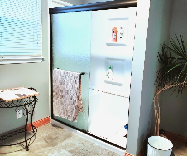 A bathroom with a shower and a sink