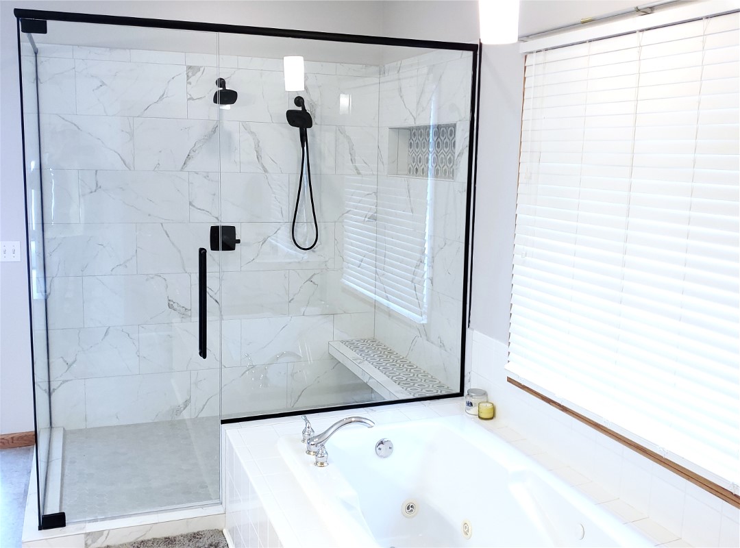 A bathroom with a shower, tub and sink.