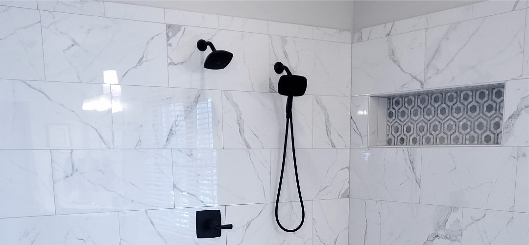 A black shower head and hand held shower