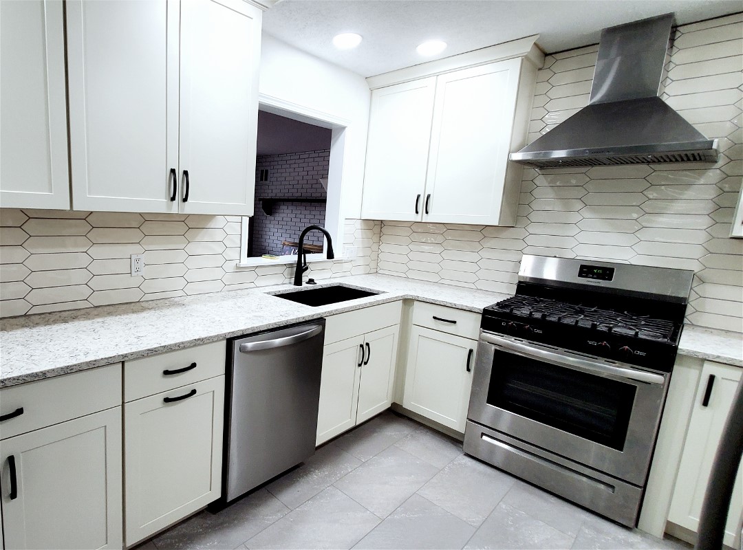 A kitchen with faucet and backsplash