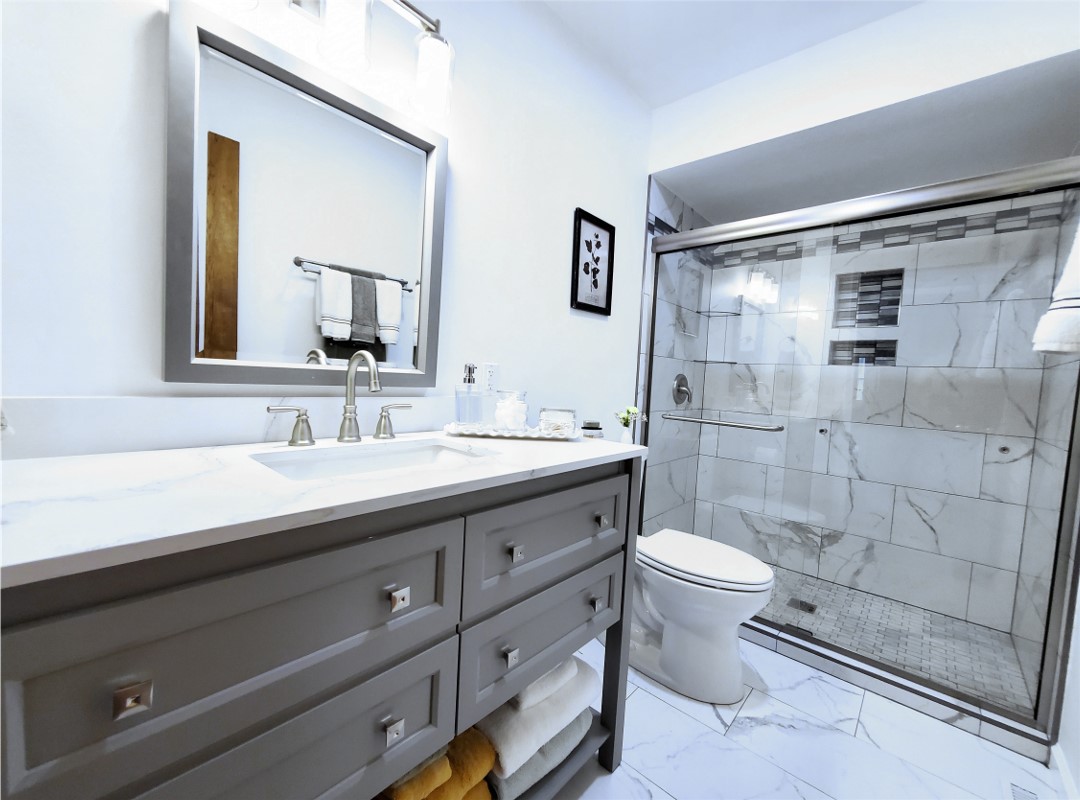 A shower area next to a toilet