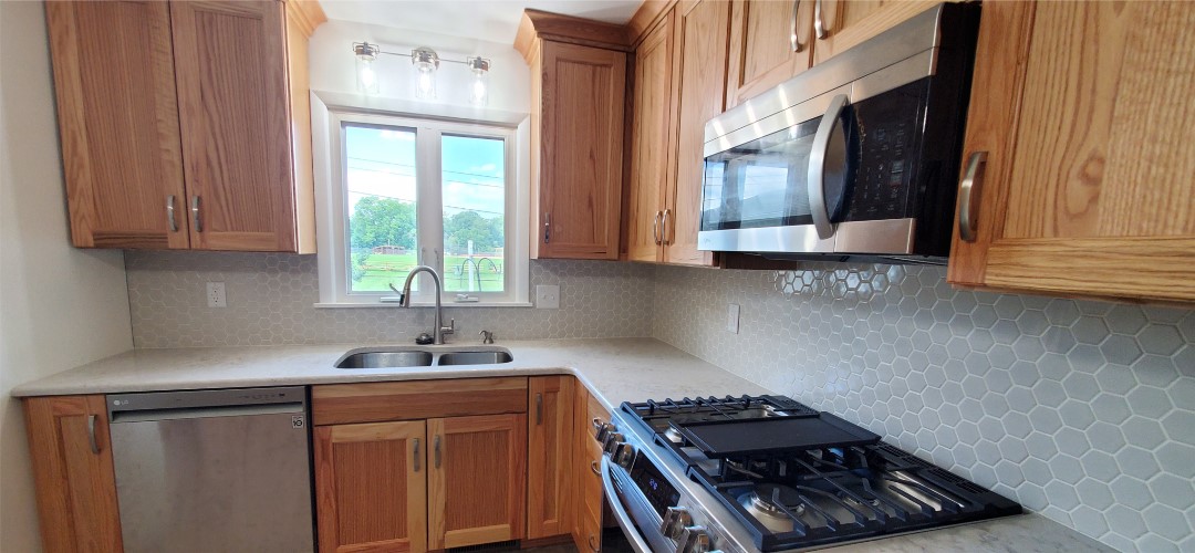 A kitchen with wooden cabinets and stainless steel appliances.