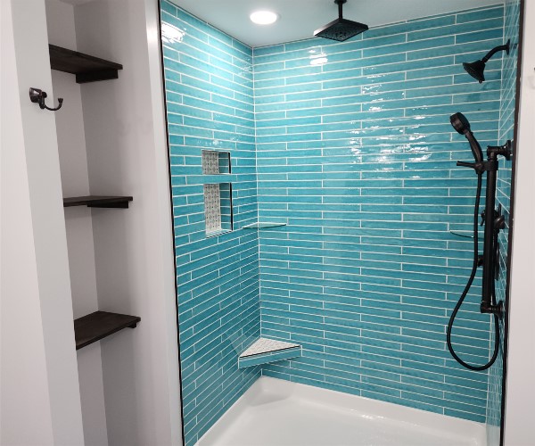 A bathroom with blue tile and white walls