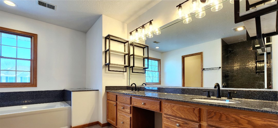 A bathroom with a sink and mirror in it