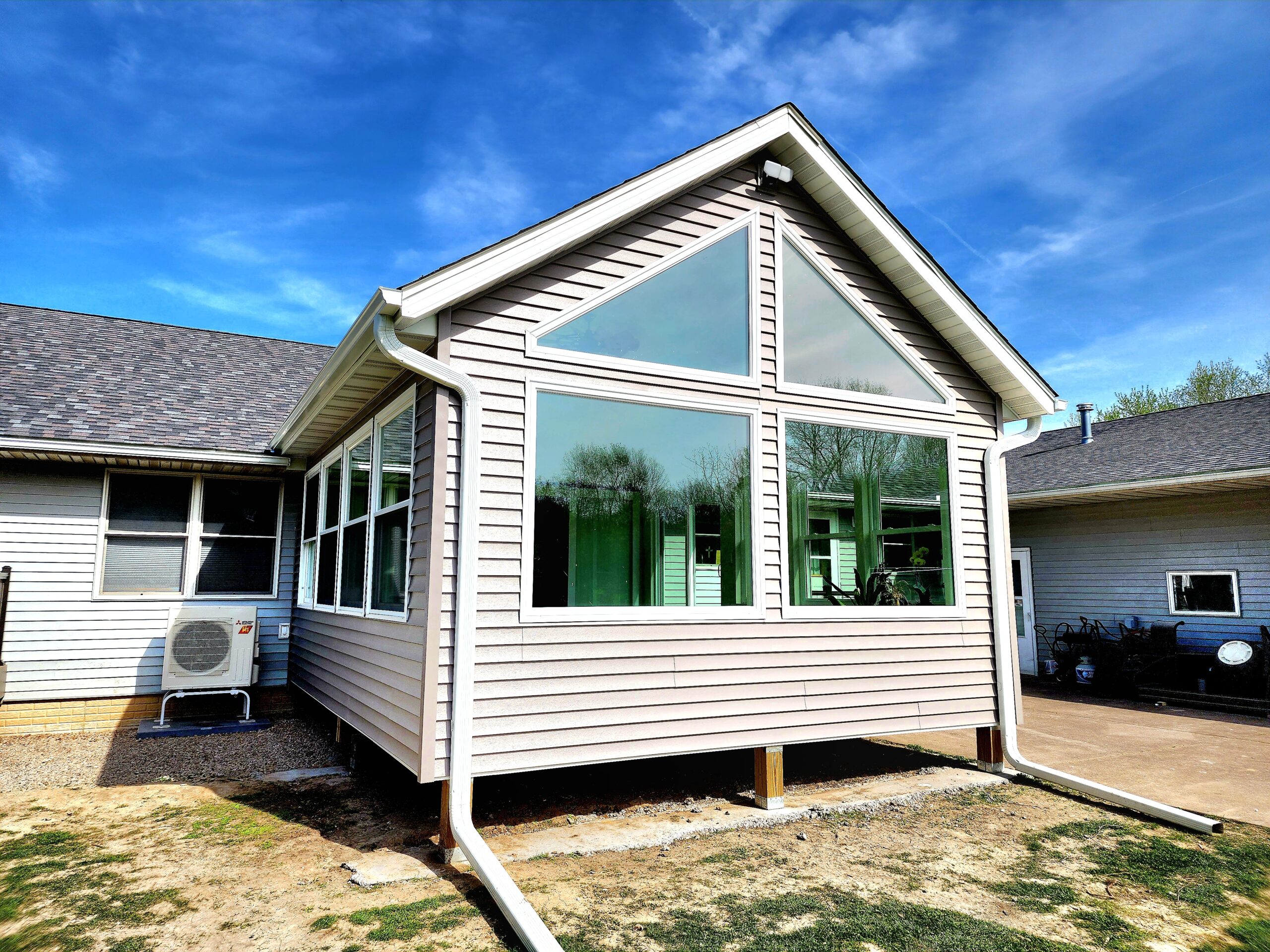 Four-season room addition with large windows in Port Byron IL by Ben Wilson Construction Services