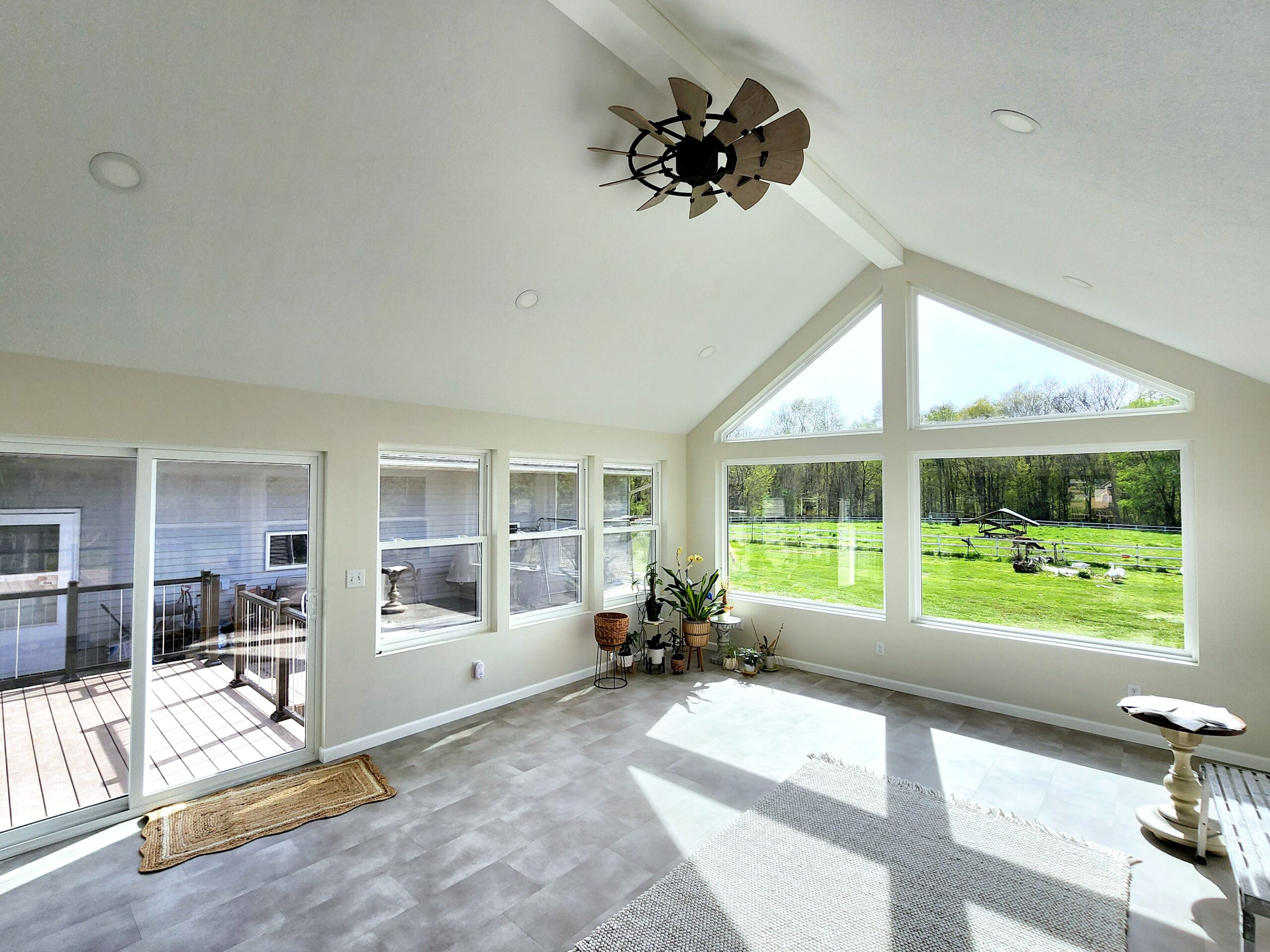 Four-season room addition with large windows in Port Byron IL by Ben Wilson Construction Services