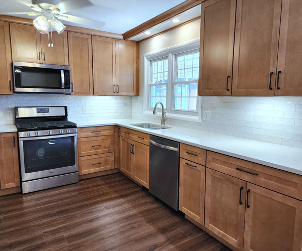 A kitchen with wood cabinets and stainless steel appliances.