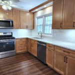 A kitchen with wood cabinets and stainless steel appliances.