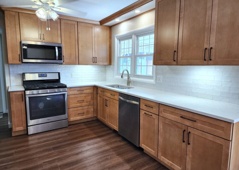 A kitchen with wood cabinets and stainless steel appliances.