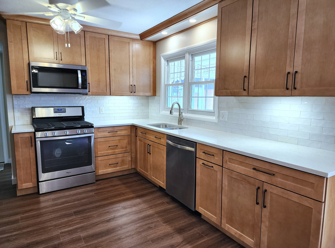 A kitchen with wood cabinets and stainless steel appliances.