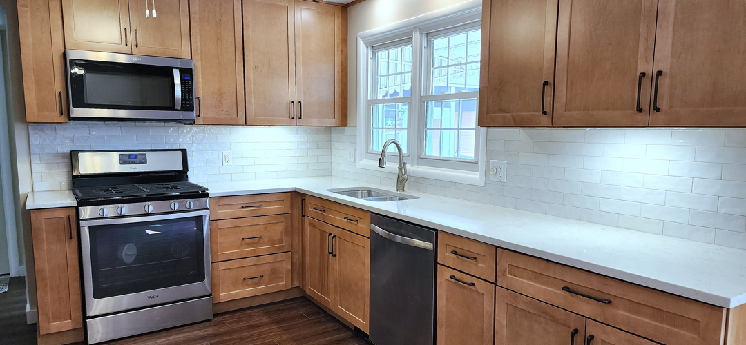 A kitchen with wood cabinets and stainless steel appliances.