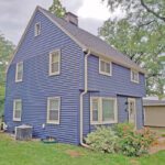 A house with blue siding and a white roof.