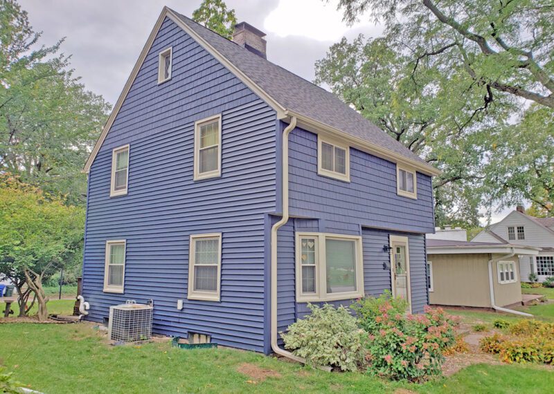 A house with blue siding and a white roof.