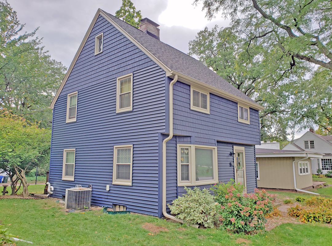 A house with blue siding and a white roof.